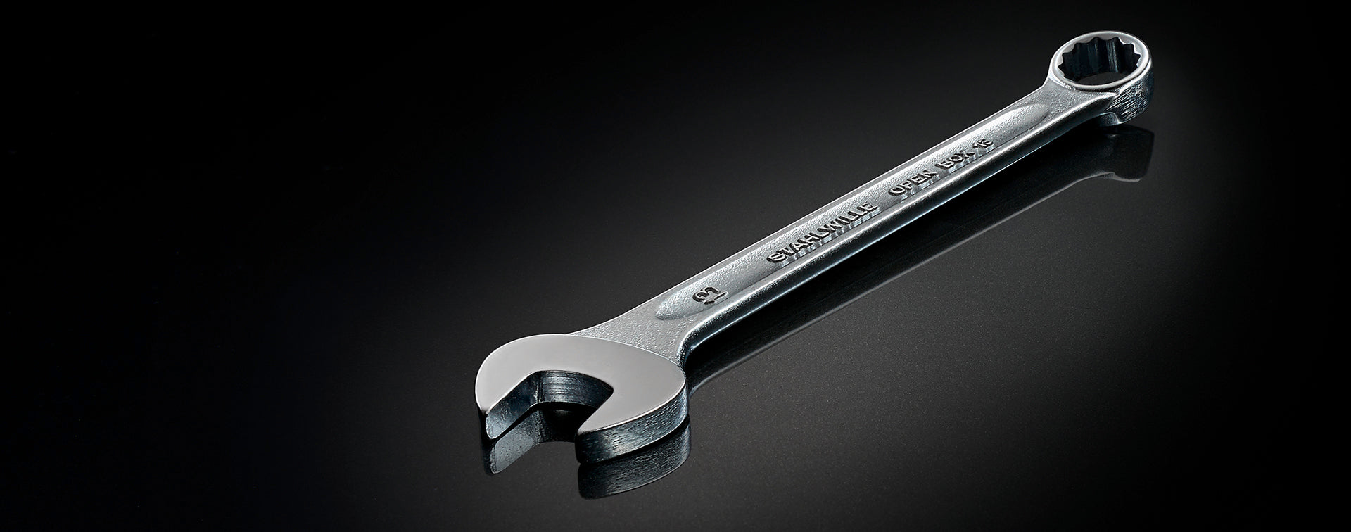 Metal wrench on a black background